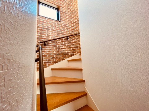 手摺付き階段で安心。
踏板と蹴込板で色が違うので視覚的に段の幅と高さを認識しやすくなっています。
機能性とデザイン性が両立された階段です。